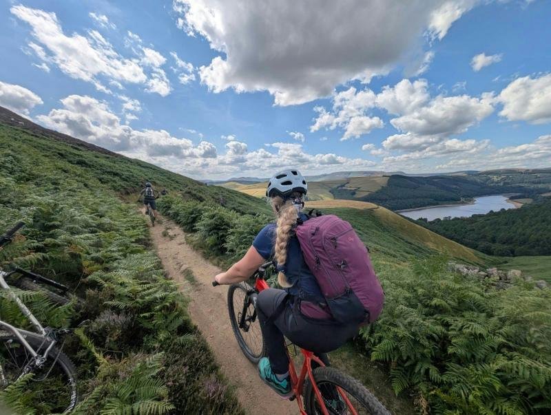 Mountain biker on singletrack above Ladybower Reservoir